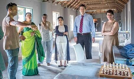 A participant of the ‘Amplified Voice Programme’ explains the workings of an installation to American Consul General Robert G Burgess