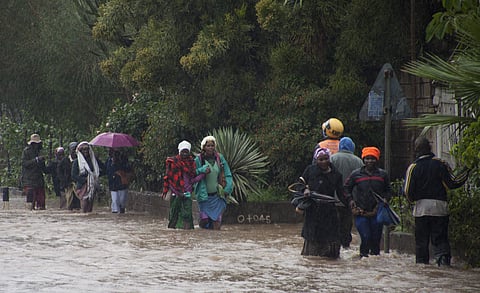 Kenyans pass through a flooded road in Nairobi, Thursday, March 15, 2018. Flooding caused by heavy rain on Thursday posed difficulties for those traveling to work. (Photo: AP)