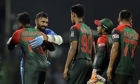 Bangladesh's team members congratulate India's Dinesh Karthik, second left, following their lost in the finals of Nidahas triangular Twenty20 cricket series in Colombo, Sri Lanka, Sunday, March 18, 2018. | AP