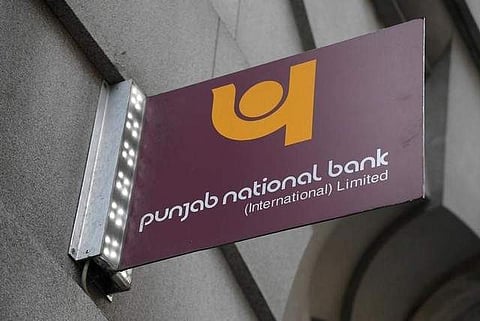 The logo of Punjab National Bank is seen outside of a branch of the bank. (Photo | Reuters)
