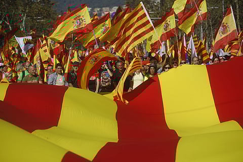 File photo of nationalist activists protest with Spanish and Catalan flags during a mass rally against Catalonia's declaration of independence. (Photo | AP)