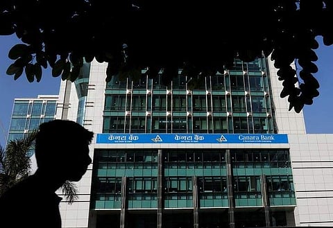 A man walks past a Canara Bank office in Mumbai. (Photo | Reuters)