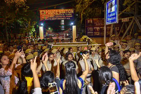 Students of Jawaharlal Nehru University JNU protest against JNU professor who is accused of sexually harsassing female students at Vasant Kunj Police Station in New Delhi on Monday. (PTI)