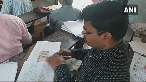 UP Board Exam students attaching currency notes to answer papers to bribe examiners (ANI UP | Twitter)