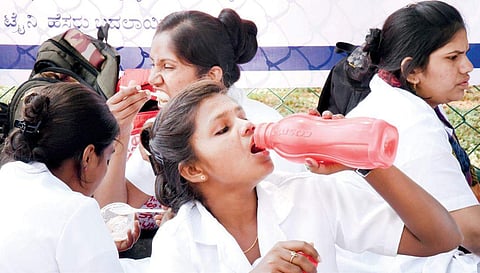 Nurses and lab technicians take a lunch break during the strike at Kidwai Memorial Institute of Oncology | nagaraja gadekal