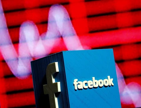 A 3D-printed Facebook logo is seen in front of a displayed stock graph in this illustration taken November 3, 2016. | Reuters