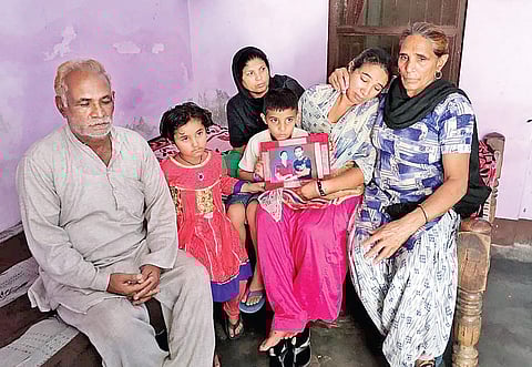 A crestfallen Harvinder Kaur, the wife of Kamaljit Singh, with her parents and two childern in Gazipur village on Tuesday.  Kamaljit was among the ill-fated Indians who were killed by ISIS terrorists in Iraq. | Harpreet Bajwa