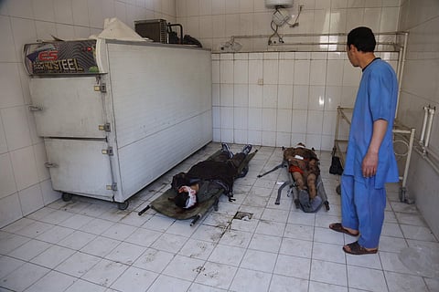Bodies of civilians lie on the ground at hospital after a suicide attack in Kabul. (Photo | AP)