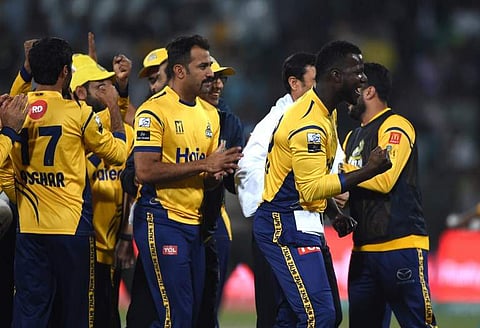 Cricketers of Peshawar Zalmi celebrate the dismissal of Anwar Ali from Quetta Gladiators during the PSL T20 cricket match in the Gaddafi Stadium in Lahore. | AFP