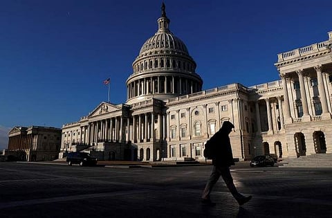 People walk by the U.S. Capitol building in Washington, U.S.| REUTERS
