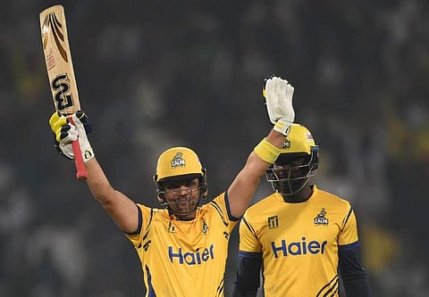 Kamran Akmal (L) of Peshawar Zalmi celebrates after he scored a half-century against Karachi King. | AFP