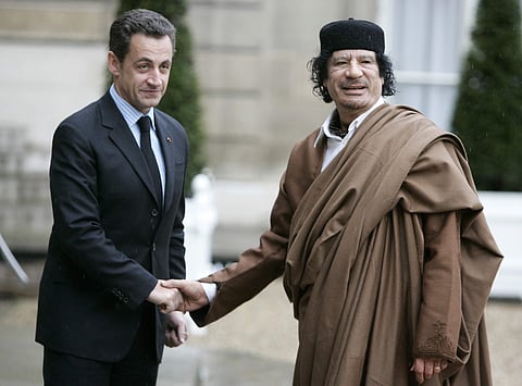 In this December 10 2007 photo, French President Nicolas Sarkozy, left, greets Libyan leader Col. Moammar Gadhafi upon his arrival at the Elysee Palace, in Paris. (File | AP)