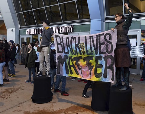 Black Lives Matter and other demonstrators protesting this week's fatal shooting of an unarmed black man gather outside Golden 1 Center before the scheduled tipoff of an NBA basketball game between the Atlanta Hawks and the Sacramento Kings in Sacramento,