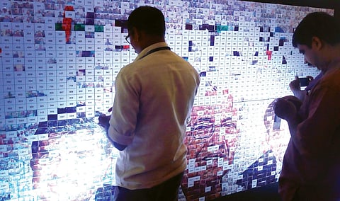 People pasting profile pictures on the Magic Wall at #Future Summit in Kochi on Thursday | Melton Antony