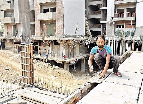 Balwant Kumar goes through his work at a private housing society near Vasundhara Sector-3 in Ghaziabad | Parveen Negi