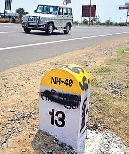 MDMK cadre spray paint over Hindi script on milestones