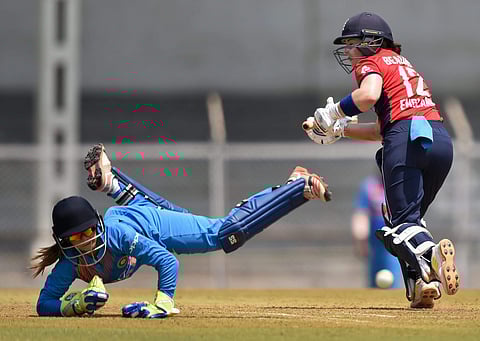 England player Tammy Beaumont plays a shot while India's wicket keeper Taniya Bhatia dives to catch the ball during the Women's T20I Tri-series cricket match played against India at Brabourne stadium in Mumbai on Sunday. | PTI