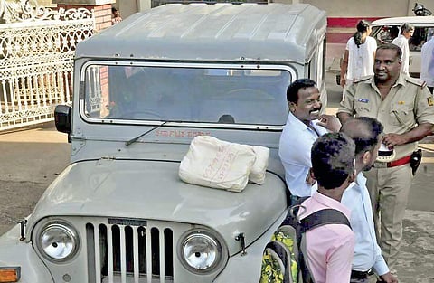 SSLC question paper bundles seen on the bonnet of a jeep in Udupi on Friday