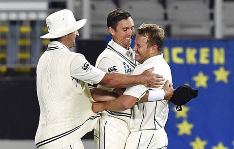 New Zealand's Neil Wagner, right, hugs Trent Boult after he took the catch off his bowling to dismiss England's Mark Stoneman for 55 during the first cricket test in Auckland. (AP)
