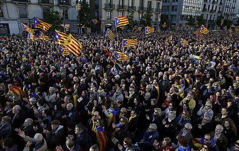 Demonstrators wave Catalan pro-independence 'Estelada' flags during a protest to demand a Catalan republic, called by the pro-independence Catalan National Assembly (ANC) citizens group in Barcelona, Spain, Sunday, March 11, 2018. | AP File Photo