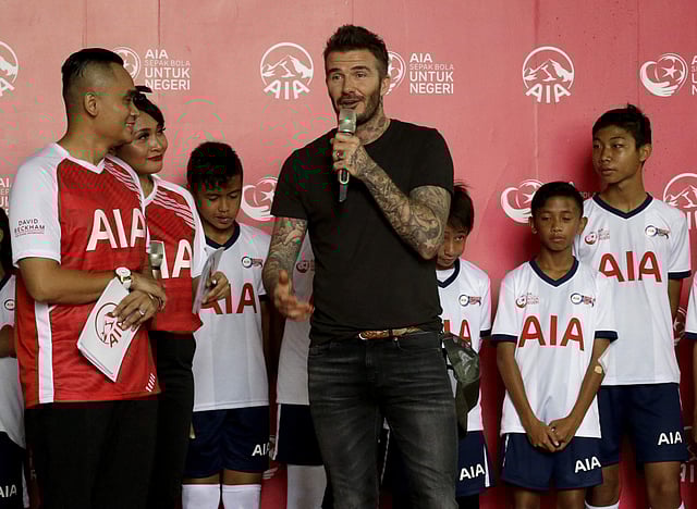 Former British soccer star David Beckham, center, speaks during a promotional event in Jakarta. | AP