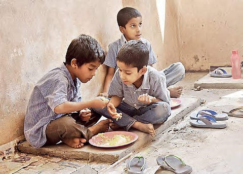 With no space to eat, schoolchildren consume their midday meal in their classroom at Rasoolpura government high school  (EPS | Vinay Madapu)