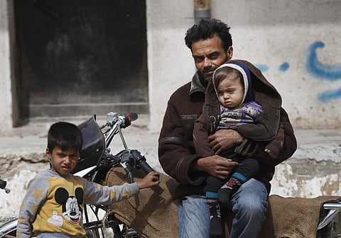 A Syrian man waits outside a food distribution centre in the northwestern city of Afrin, Syria. | AP