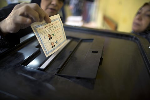 A woman casts her vote during the second day of the presidential election at a polling station in Cairo, Egypt, Tuesday, March 27, 2018.(AP)