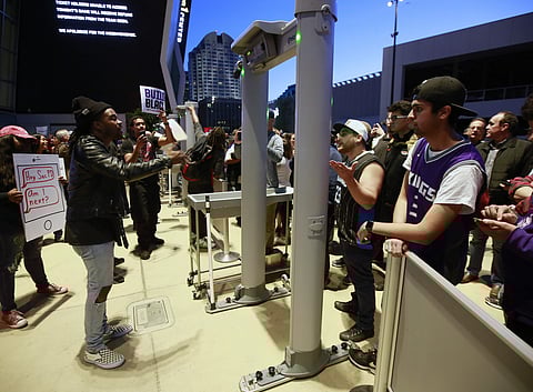 A demonstrator, left, talks with a Sacramento Kings ticket holder, right, during a protest over the shooting death of Stephon Clark by Sacramento Police officers on March 18, causing a lockdown of the Golden 1 Center in Sacramento, Calif. | AP