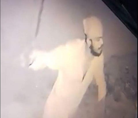 Screengrab from CCTV footage of drunk biker attacking police.