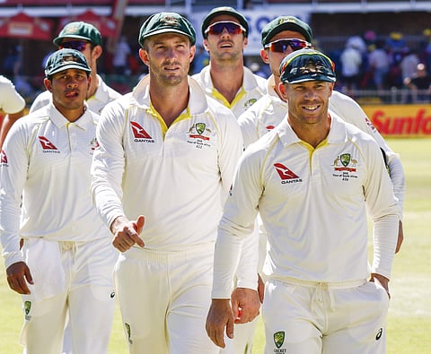 Australia's David Warner, right, leads his team off the field after losing the second cricket test between South Africa and Australia at St. George's Park in Port Elizabeth. | File AP