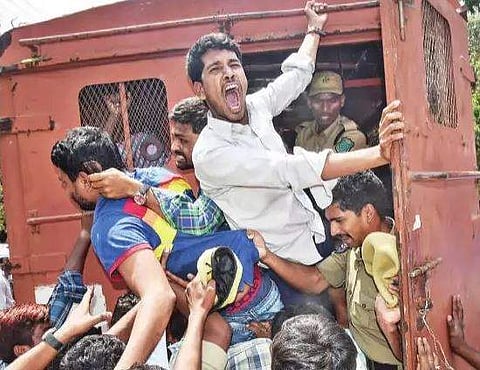 Students raising slogans as cops try to lock them in van while they stage protest against Private Universities Bill at Osmania University Arts College in Hyderabad on Wednesday | vinay madapu