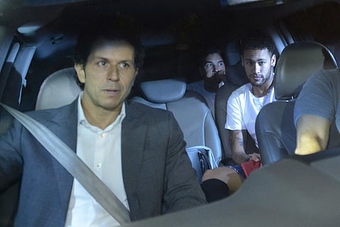 Brazil soccer star Neymar, right, and his doctor Rodrigo Lasmar, left, arrive to the Mater Dei Hospital, in Belo Horizonte. | AP