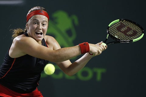 Jelena Ostapenko returns a shot from Danielle Collins during a semifinal at the Miami Open. | AP
