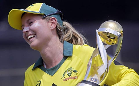 Australia's captain Meg Lanning with the trophy smiles after winning the final of Women's cricket T20 Triangular Series in Mumbai. | AP