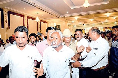 Dalit protesters being led out by police during BJP national chief Amit Shah’s meeting in Mysuru on Friday  | Udayshankar S