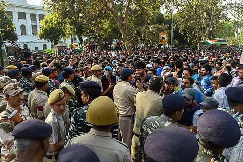 Police detain students during their Yuva Halla Bol protest over SSC scam in New Delhi on Saturday. | PTI