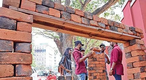 College students use bricks collected from the Attukal Pongala hearths for an installation in T’Puram on Saturday  | B P Deepu