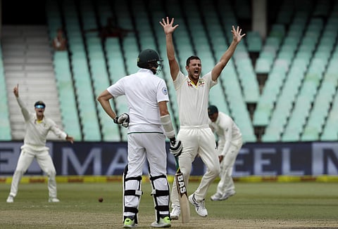 Australia's bowler Josh Hazlewood, right, successfully appeals for LBW against South Africa's batsman Quinton de Kock on the fifth and final day of the first cricket test match. | AP