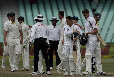 South Africa's batsman Quinton de Kock‚ fourth right, and teammate Morne Morkel‚ second right, at the end of the fifth and final day of the first cricket test match between South Africa and Australia at Kingsmead stadium in Durban, South Africa, Monday, M