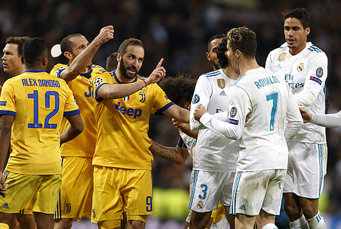 Real Madrid's Cristiano Ronaldo argues with Juventus' Gonzalo Higuain during a Champions League quarter final second leg soccer match between Real Madrid and Juventus at the Santiago Bernabeu stadium in Madrid, Wednesday, April 11, 2018. | AP
