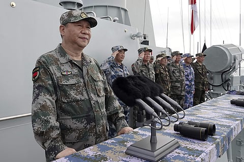 Chinese President Xi Jinping, left, speaks after he reviewed the Chinese People's Liberation Army (PLA) Navy fleet in the South China Sea.