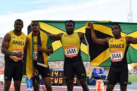 amaica’s Everton Clarke, Oshane Bailey, Warren Weir, Yohan Blake pose with their flag after the athletics men's 4x100m relay final during the 2018 Gold Coast Commonwealth Games at the Carrara Stadium on the Gold Coast on April 14, 2018.  (Photo: AFP)
