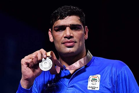 Silver medallist India's Satish Kumar attends the medal ceremony for the men's 91kg boxing event during the 2018 Gold Coast Commonwealth Games at the Oxenford Studios venue on the Gold Coast on April 14, 2018. (Photo: AFP)