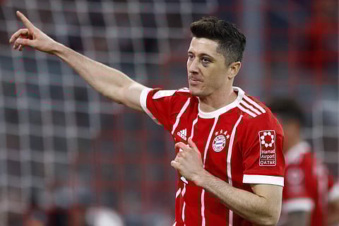 Bayern's Robert Lewandowski celebrates after scoring his side's fifth goal during the German Bundesliga soccer match between FC Bayern Munich and Borussia Moenchengladbach in Munich, Germany, Saturday, April 14, 2018. | AP