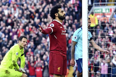 Liverpool's Mohamed Salah celebrates scoring his side's second goal of the game during the English Premier League soccer match between Liverpool and Bournemouth at Anfield, Liverpool, England. Saturday April 14, 2018. | AP