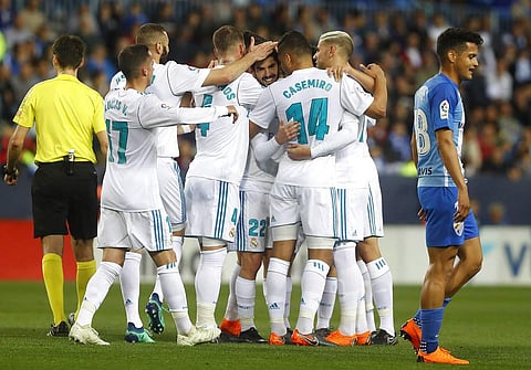 Real Madrid's Isco, celebrates with teammates after scoring against Malaga during the La Liga soccer match at the Rosaleda stadium, in Malaga, Spain. (AP)