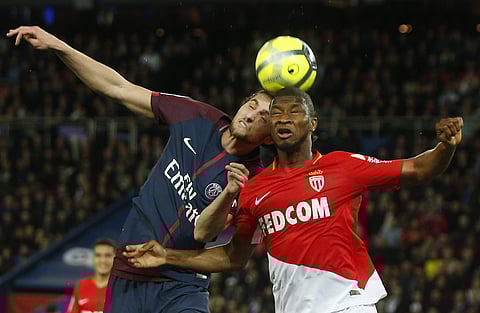 Monaco's Almamy Toure, right, and Paris Saint Germain's Adrien Rabiot, left, head the ball during the French League One match between Paris Saint Germain and Monaco at the Parc des Princes stadium in Paris, France. (AP)