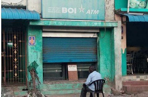 An ATM on half shutter due to non-availability of cash. (EPS)