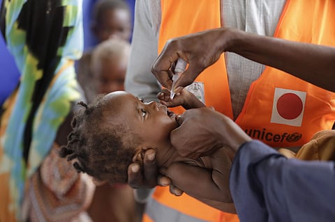 In this photo a health official from Unicef administers a polio vaccine to a child at a camp for displaced African people (File | AP)